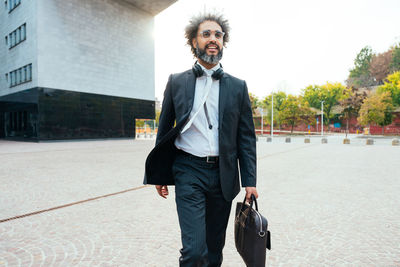 Portrait of businessman standing on street