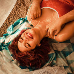 High angle view of woman lying on bed