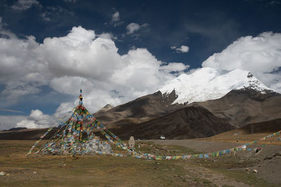 Scenic view of tibetan prayer flags against a  mountains and sky background