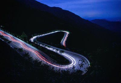 High angle view of light trails on road at night