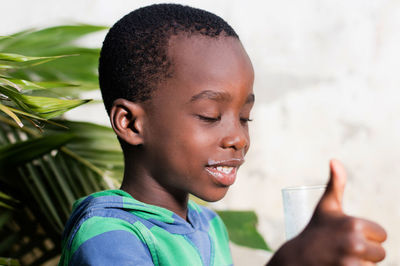 Boy drinking milk and gesturing