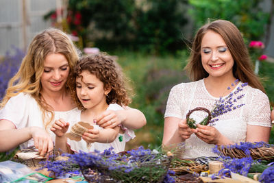 Portrait of a smiling young woman against plants