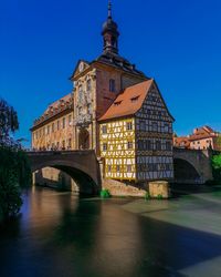 Arch bridge over river against buildings