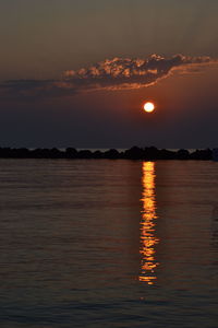 Scenic view of sea against romantic sky at sunset