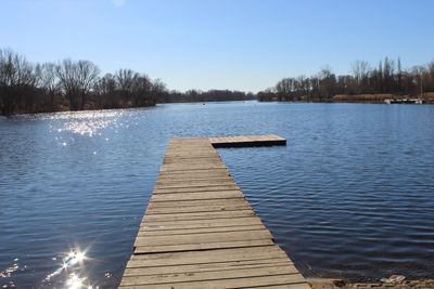 Pier over lake against sky