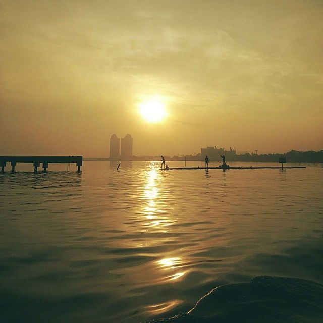 sunset, water, sun, orange color, silhouette, reflection, scenics, tranquil scene, waterfront, tranquility, sky, beauty in nature, sea, idyllic, nature, sunlight, rippled, transportation, nautical vessel, cloud - sky