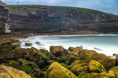 Scenic view of sea and rocks against sky