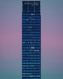 Low angle view of modern building against blue sky