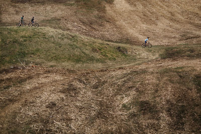 People riding bicycle on field