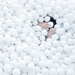 High angle view of woman enjoying in white ball pool
