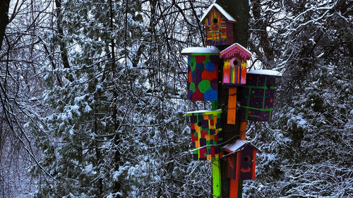 Low angle view of birdhouse on snow covered building