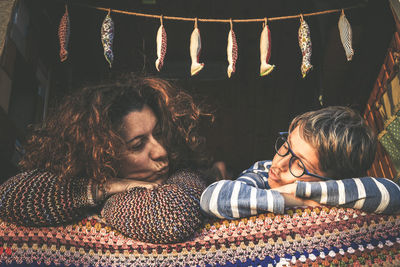 Mother and son puckering while lying on sofa