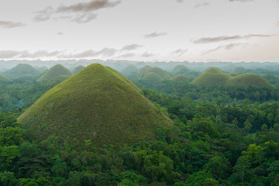 Scenic view of green mountains against sky