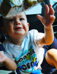 Cute boy sitting in car