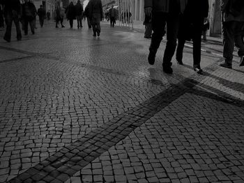 Low section of people walking on street