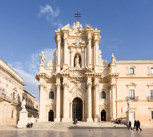 Facade of historic building against sky in city