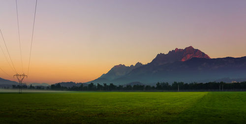 Scenic view of field against sky during sunset