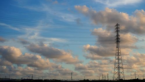 Low angle view of electricity pylon against sky
