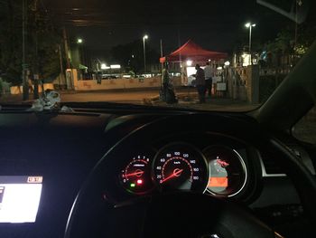 Cars moving on illuminated car in city at night