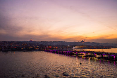 High angle view of bridge over sea against sky during sunset