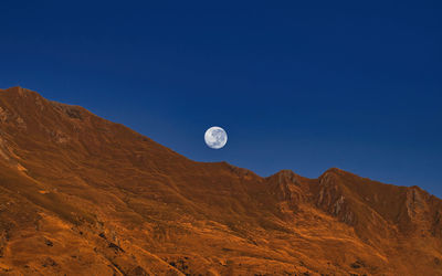 Scenic view of mountains against clear blue sky