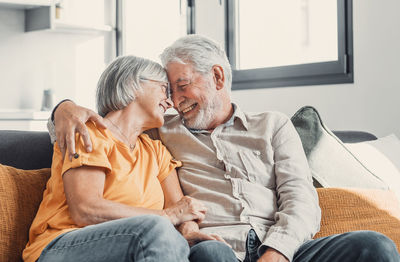 Side view of senior couple sitting at home