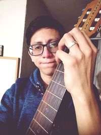 Portrait of man holding guitar