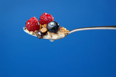 Close-up of strawberry against blue background