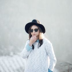 Young woman wearing sunglasses and hat