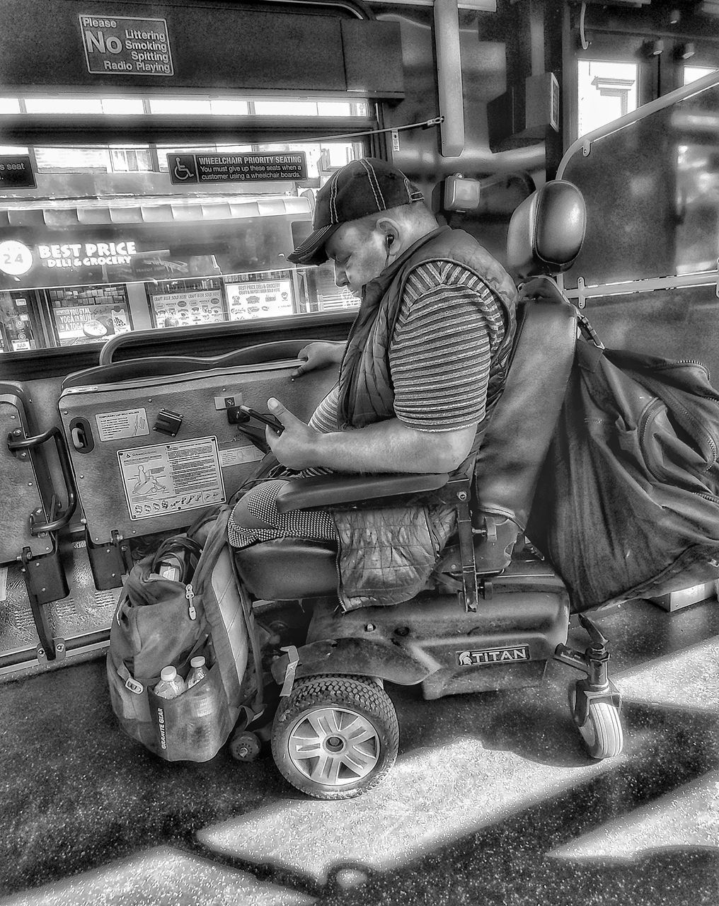 SIDE VIEW OF A MAN SITTING IN ILLUMINATED STORE