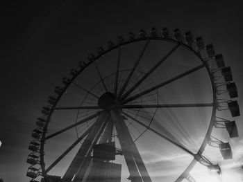 Low angle view of ferris wheel against sky