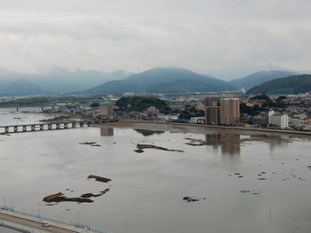 Scenic view of buildings and mountains against sky