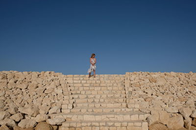 Woman standing against clear sky