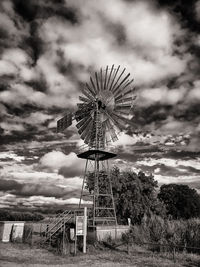 Ferris wheel on field against sky