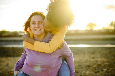 Portrait of lesbian woman with girlfriend on field