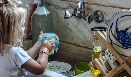 Midsection of woman having food at home