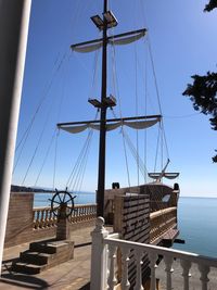 Sailboat by sea against clear sky