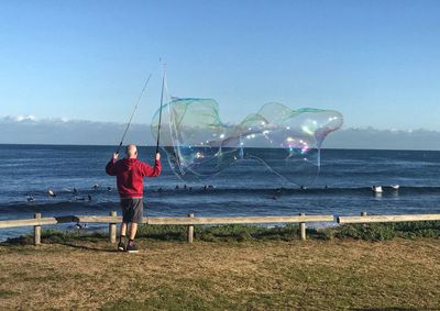 Man on beach against sky