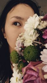 Close-up portrait of woman with pink flowers