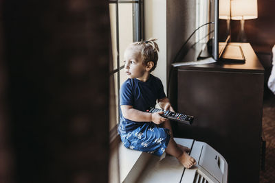 Boy playing guitar at home