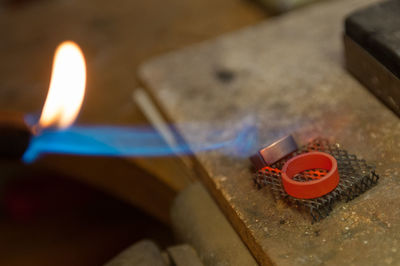 High angle view of lit candles on metal