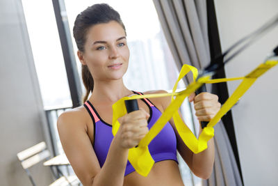 Young woman exercising in gym