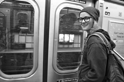 Portrait of smiling woman in train 