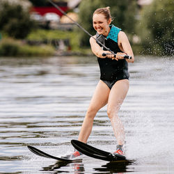 Full length of woman splashing water