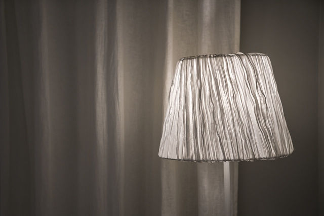 Illuminated electric lamp against curtain | ID: 131569720