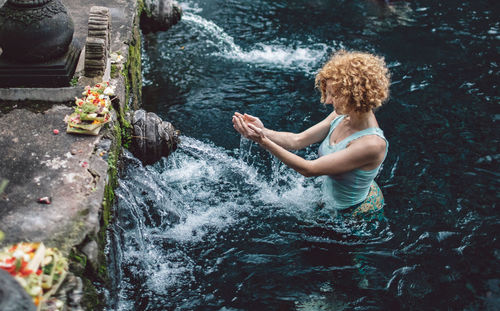 Woman looking at water spring