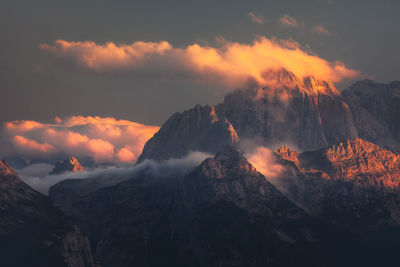 Aerial view of snowcapped mountains against sky during sunset