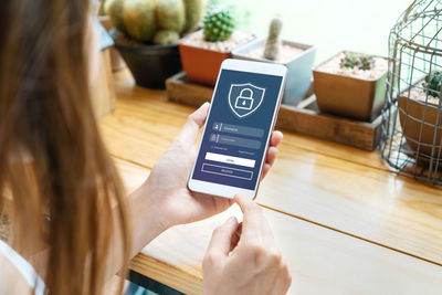 Midsection of woman using mobile phone