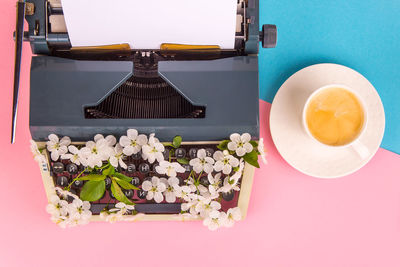 Typewriter with white flowers from the keys - spring. creative writing concept. top view, flat lay