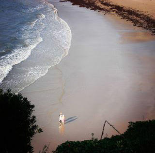 WOMAN PHOTOGRAPHING AT SHORE